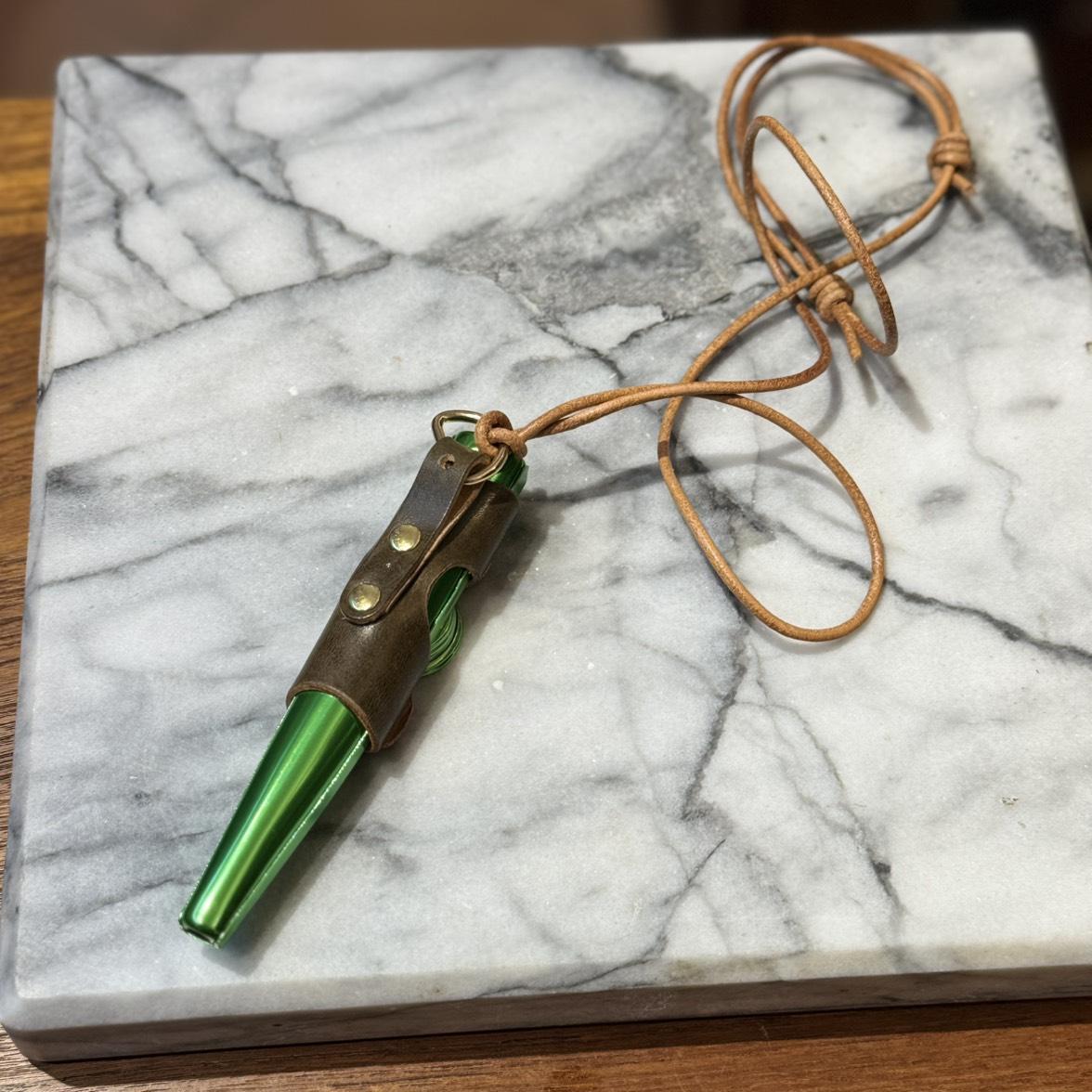 Kazoo with a neck strap
