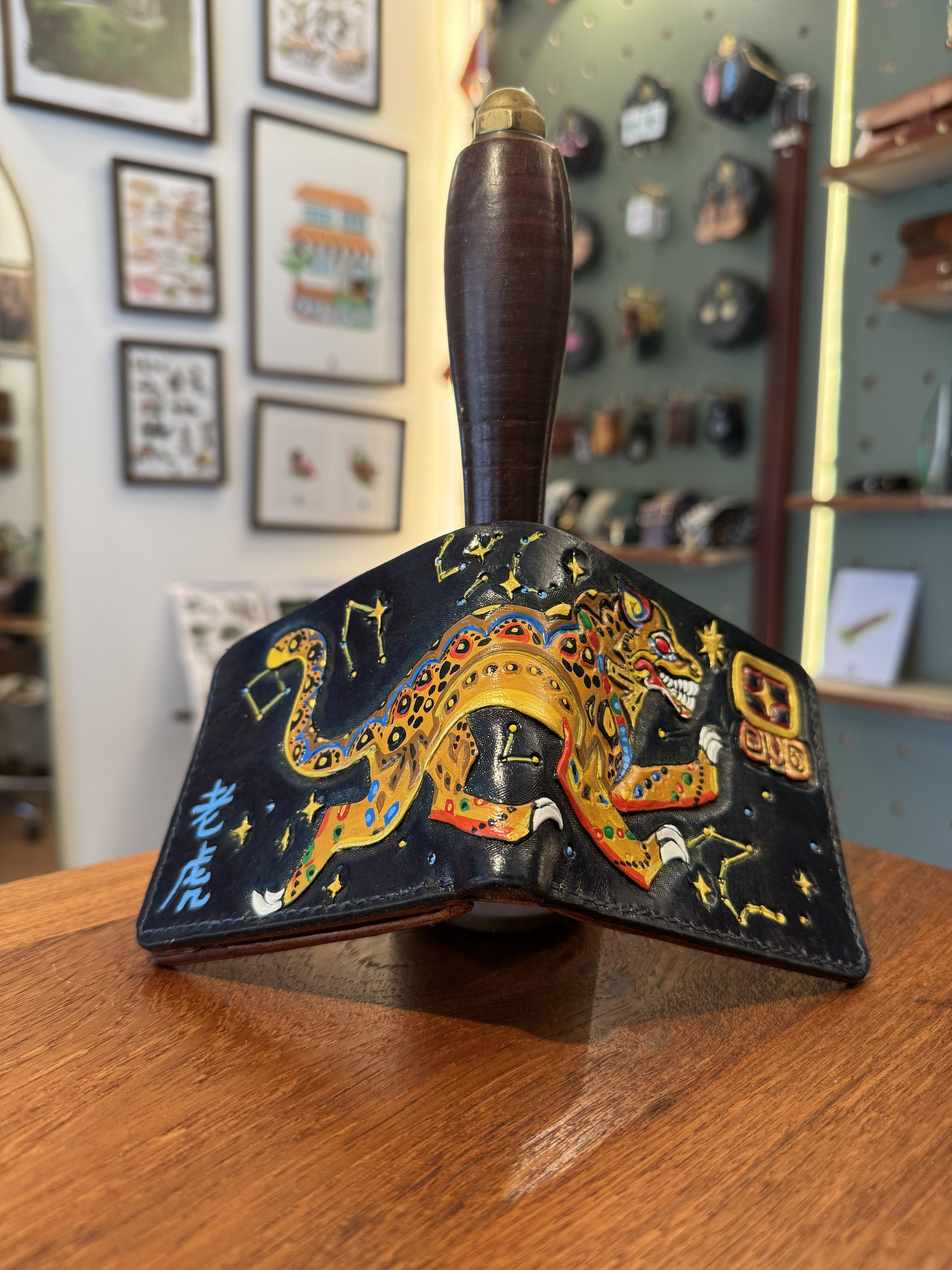 A magnificent custom wallet for Carlos, carved with a unique piece of art designed to depict Mayan Heritage in the form of a stylised leopard, leaping across the constellation of the "Tiger of the West" from Chinese folklore.
