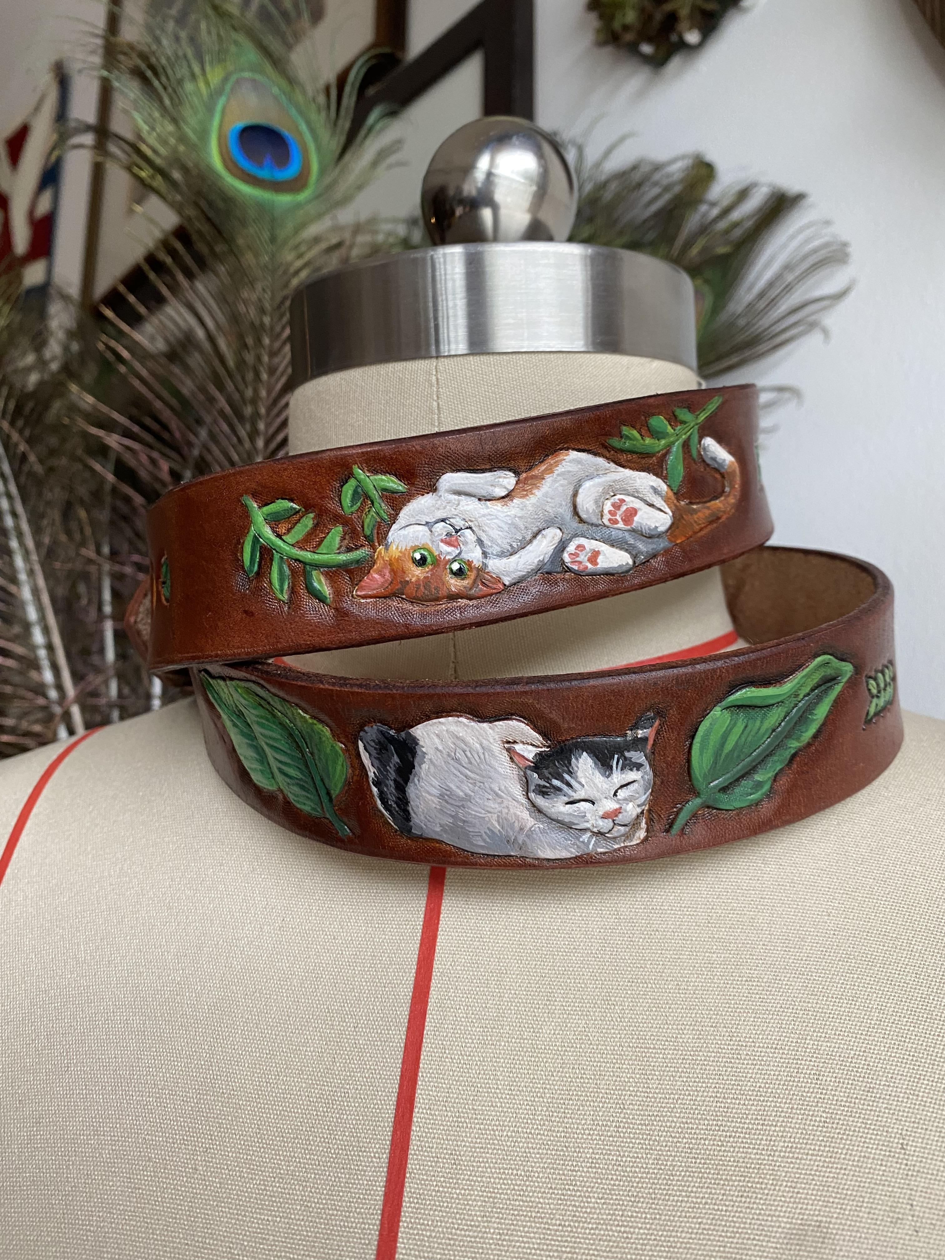 A beautiful one-of-a-kind belt featuring the cats that would visit the client's garden. A beautiful memento for a garden in time.