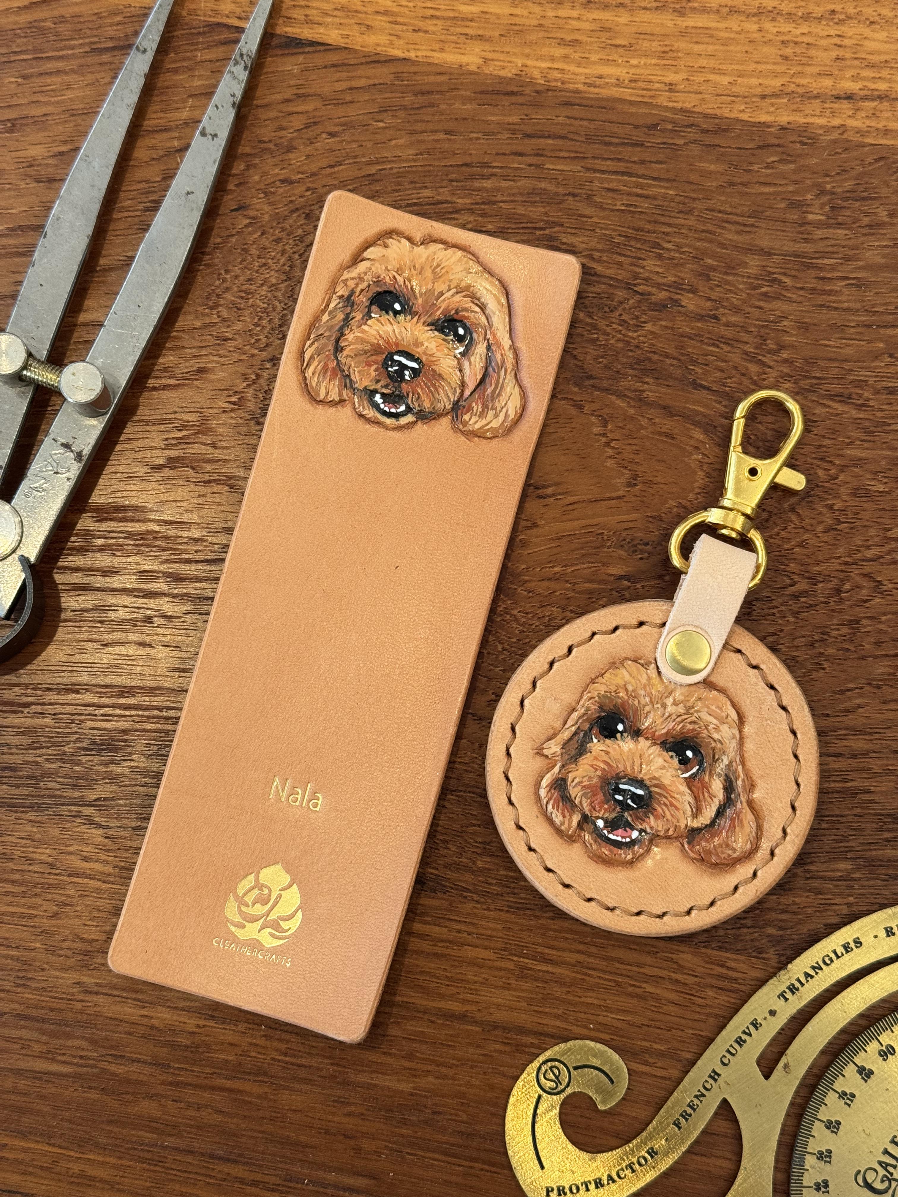 A matching set of a keychain and a bookmark with pawtraits of Nala. Hand carved on Hermann Oak tooling leather with her name gold foil embossed on each piece.